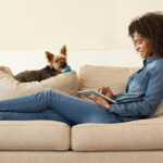Vrouw met tablet op bank