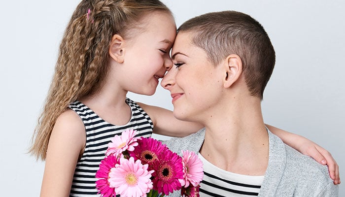 Dochter geeft bloemen aan moeder