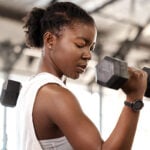 Dame traint haar linkerbicep met dumbbell